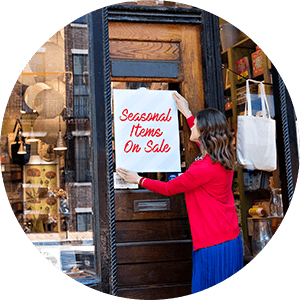 woman hanging seasonal sign
